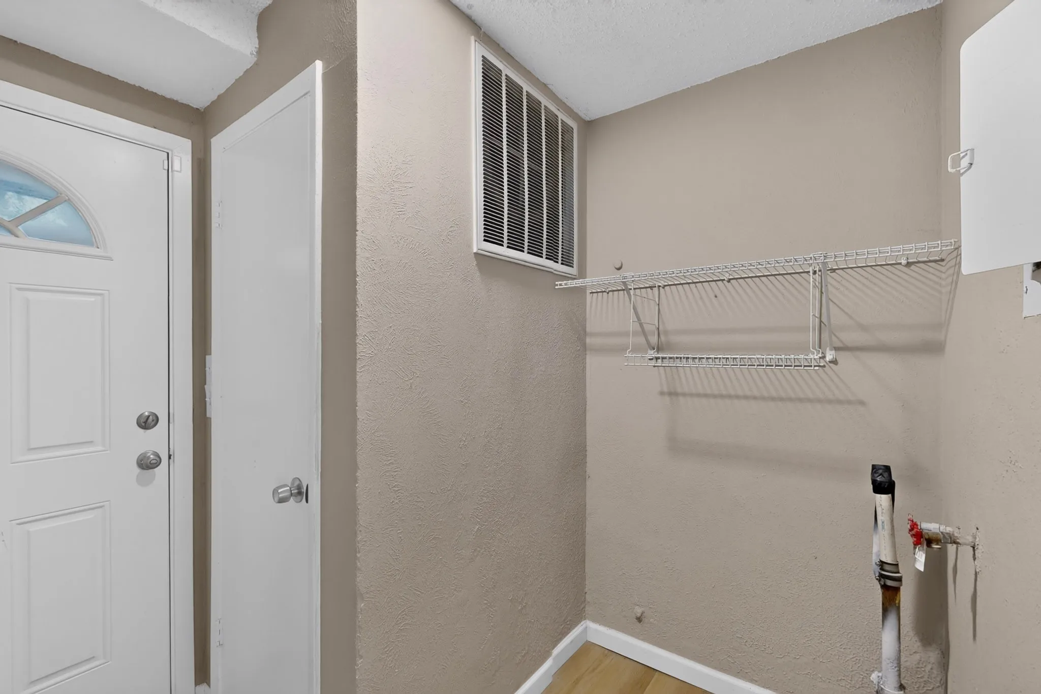 White paneled door with arched glass insert