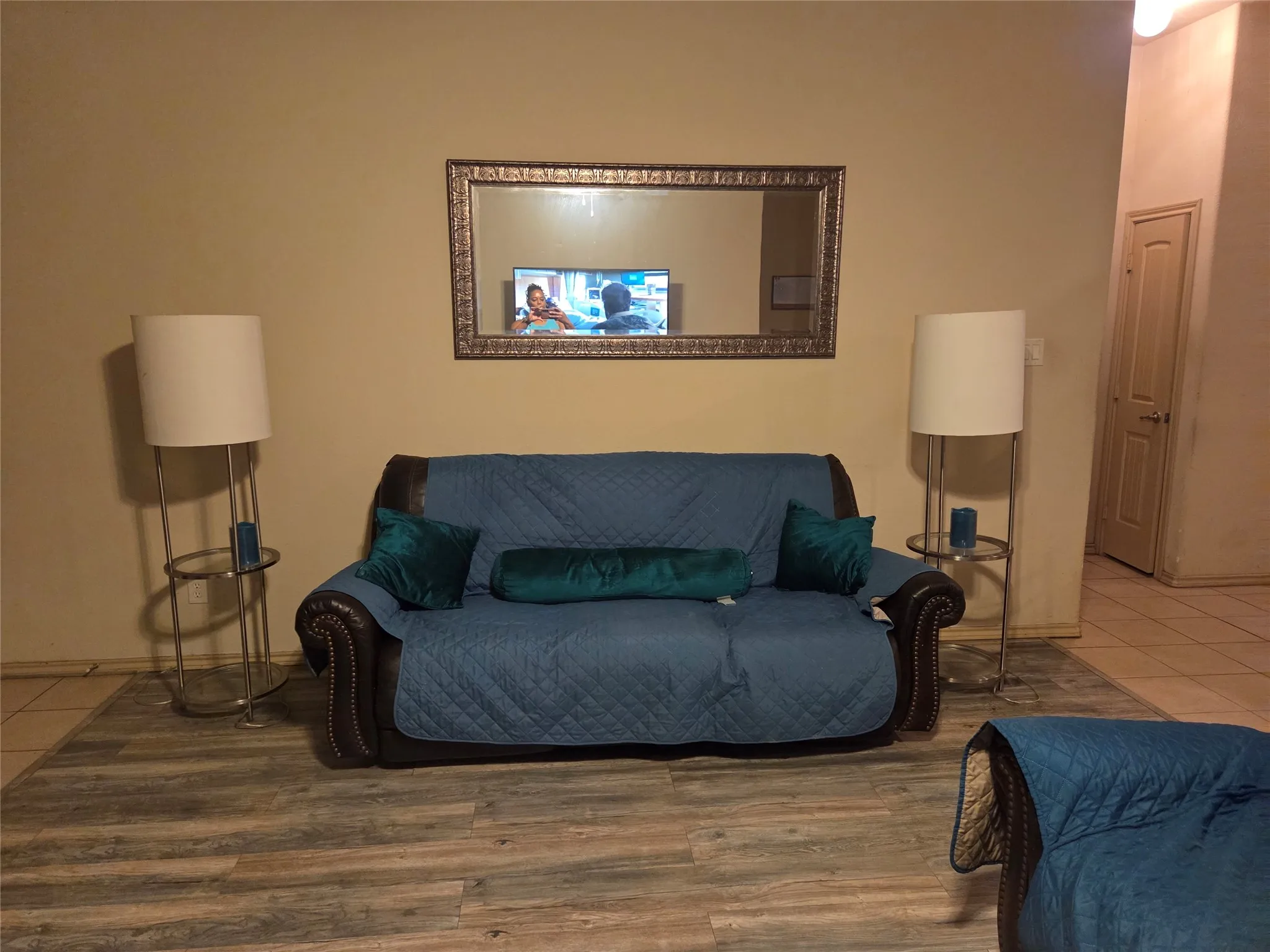 Wood-finish flooring throughout, complemented by a decorative wall mirror
