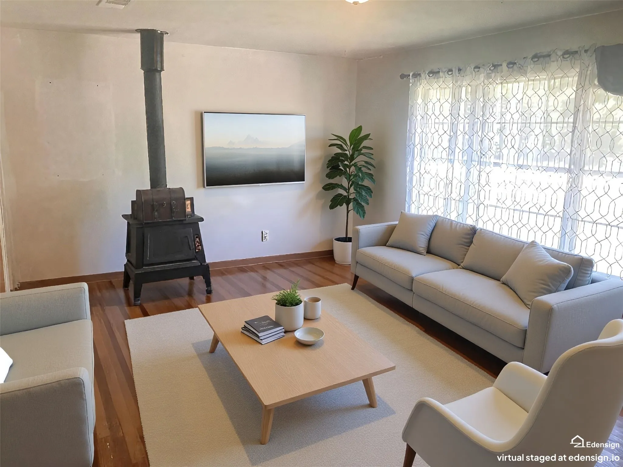 Hardwood flooring, large window with sheer curtains, recessed lighting, and a prominent black wood-burning stove