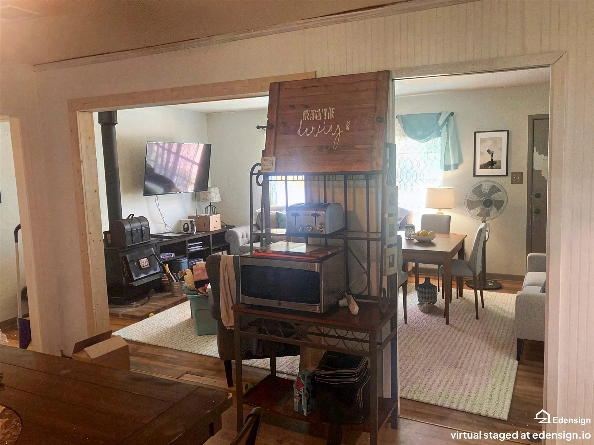 Wood-finish flooring throughout, featuring an open doorway with wood trim