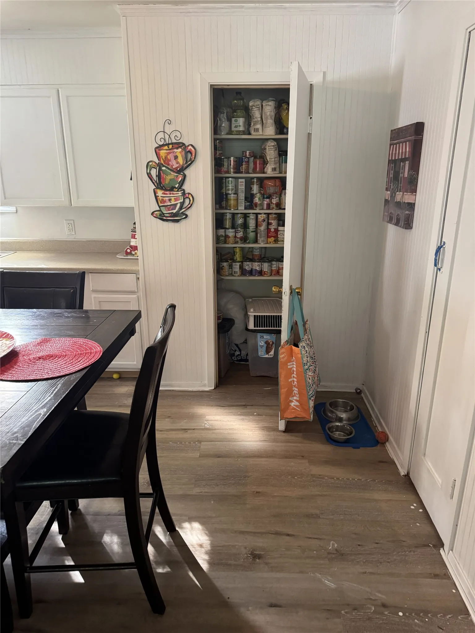 Kitchen featuring white cabinetry and light countertops