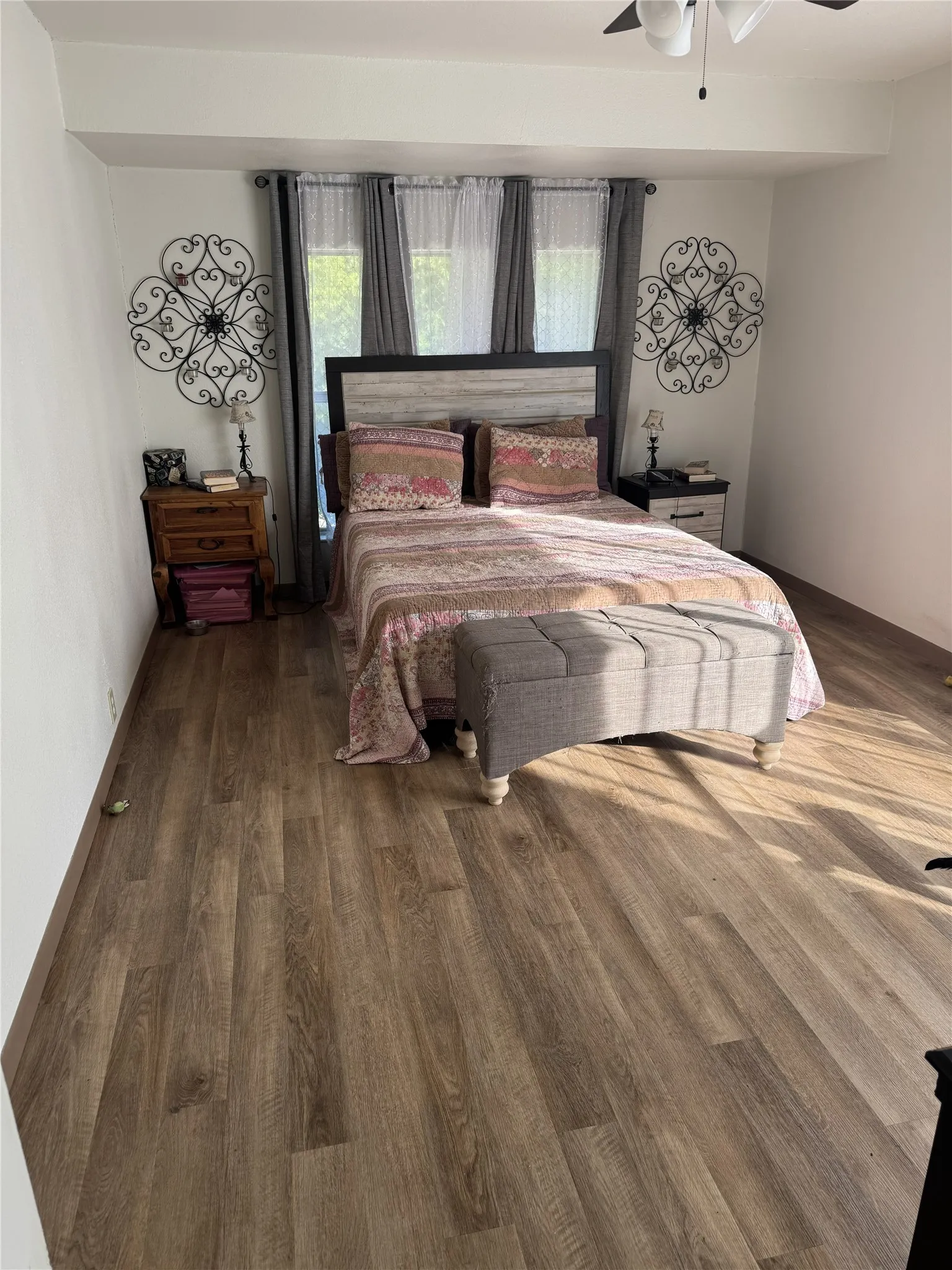 Wood-finish flooring throughout, complemented by a ceiling fan