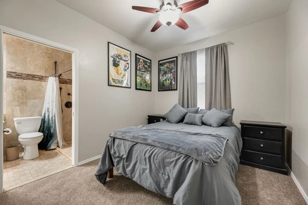 Recessed lighting, ceiling fan, wall-to-wall carpeting, and an attached three-piece bathroom with tiled walls and flooring