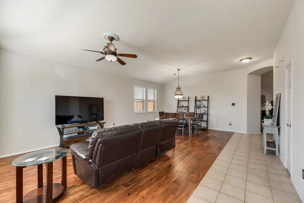 Open-concept living space featuring wood-finish flooring, a ceiling fan, and recessed lighting
