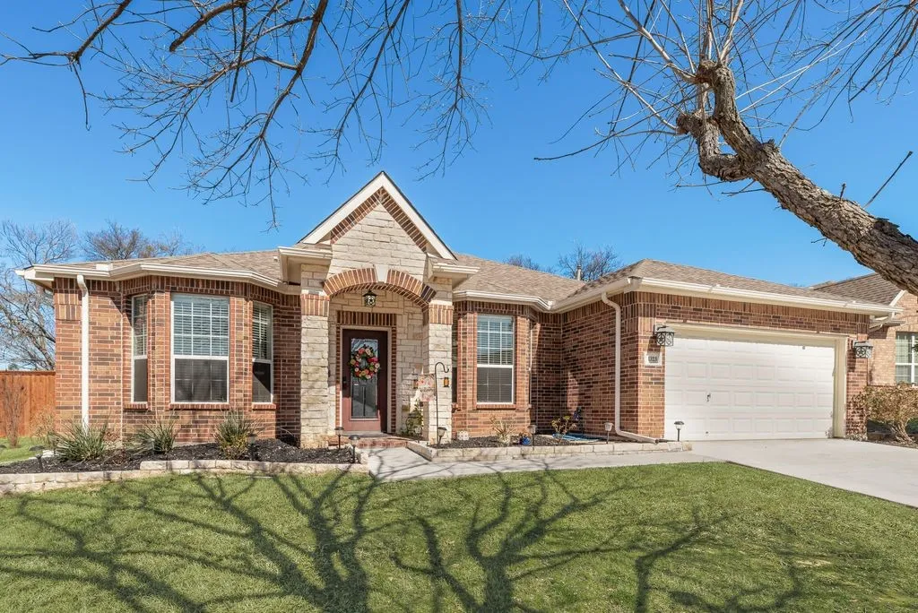 Brick exterior with stone accents and a covered entryway