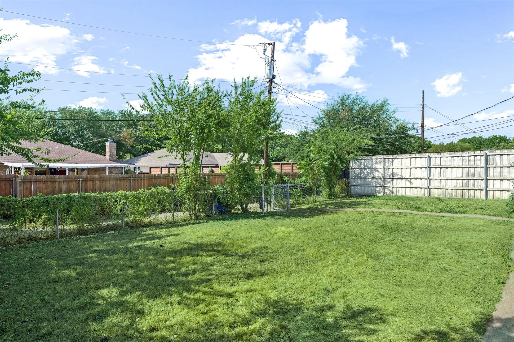 Backyard has large grassy area.