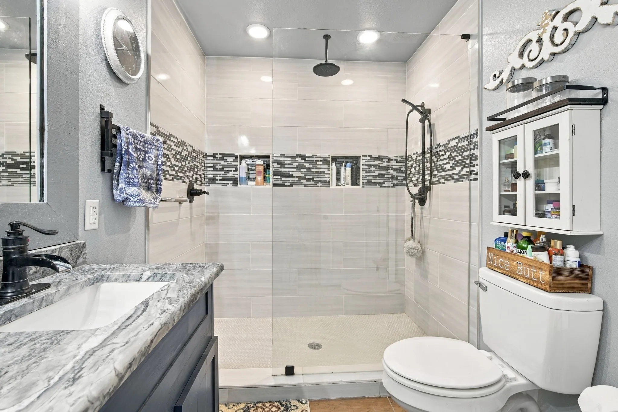 Walk-in shower with full-height tile surround and glass enclosure
