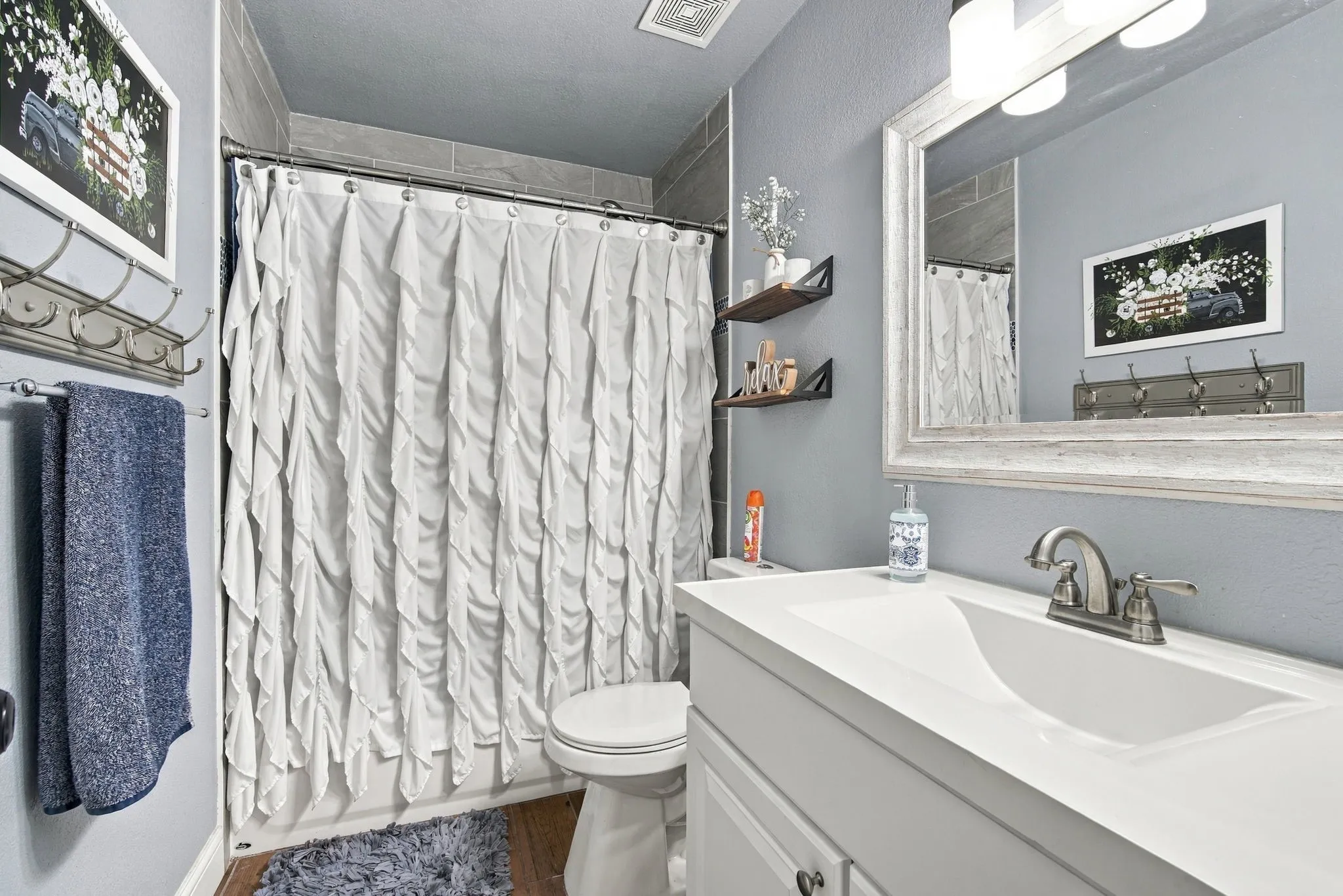 Built-in vanity with integrated basin, brushed nickel faucet, and a framed mirror