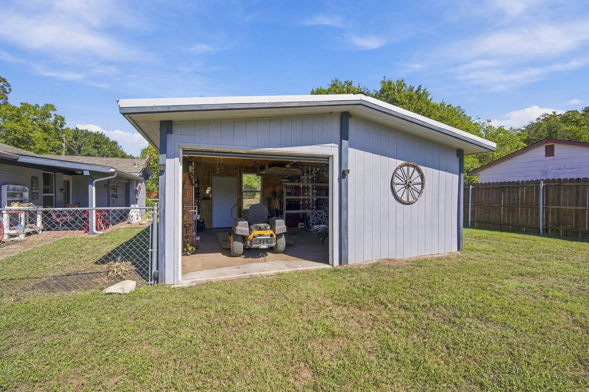 Detached outbuilding with an overhead garage door and vertical siding