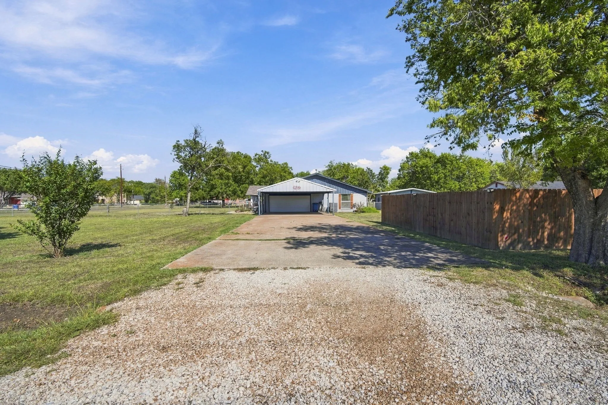 side entry drive way featuring the two car garage with additional two car carport and plenty of room for your friends and family to park.