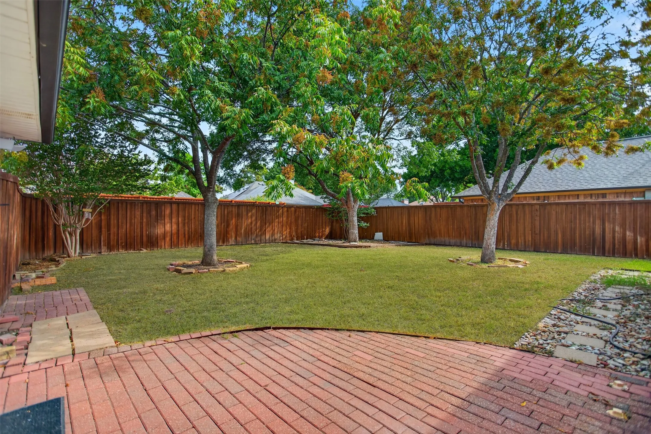 Shaded yard with board on board fence