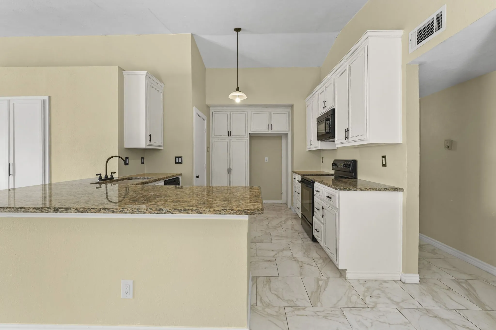 Kitchen featuring white cabinetry, stone-finish countertops, stainless steel appliances, and tile flooring