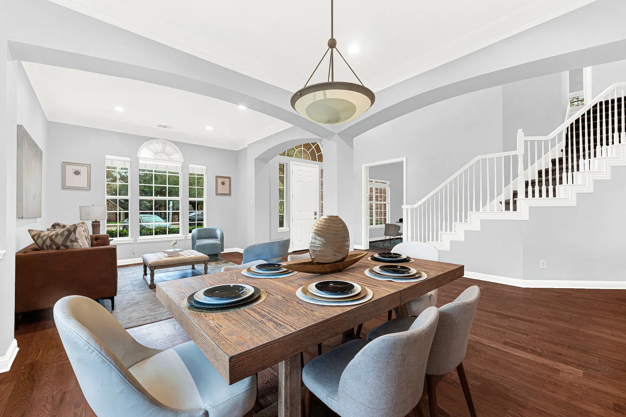 Light color palette with rich hardwood floors throughout the primary living spaces