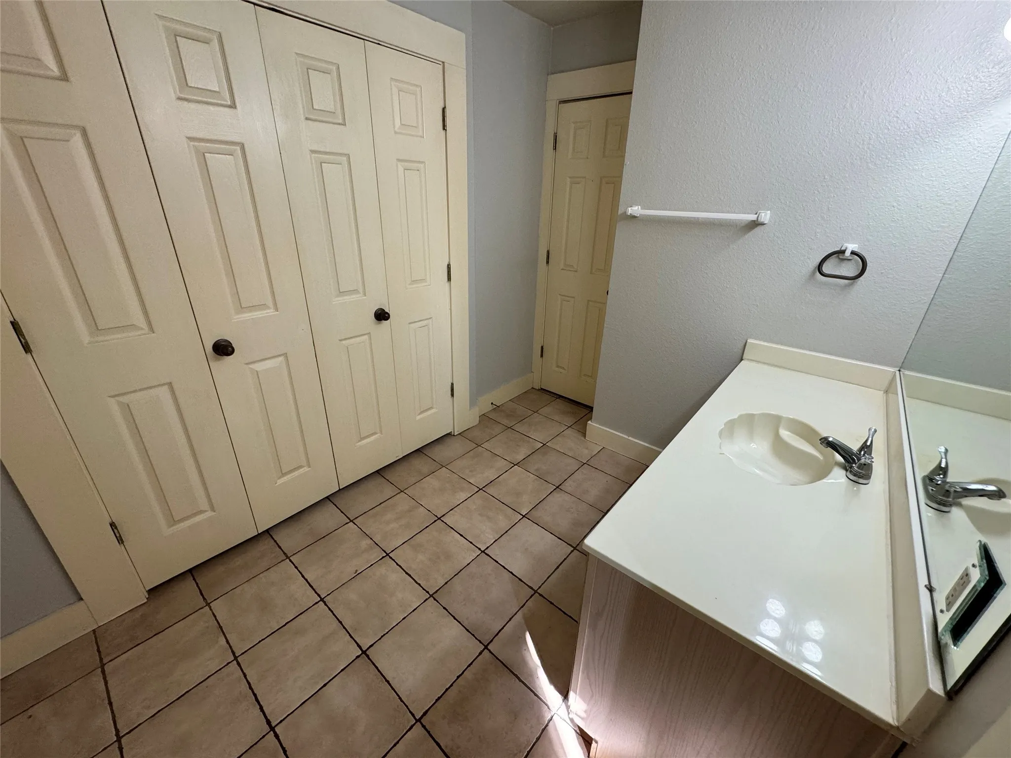 Bathroom featuring tile patterned flooring and sink