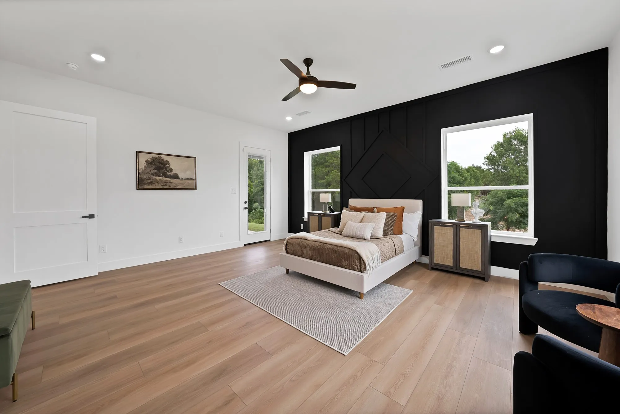 Expansive wood-finish flooring, recessed lighting, and a ceiling fan
