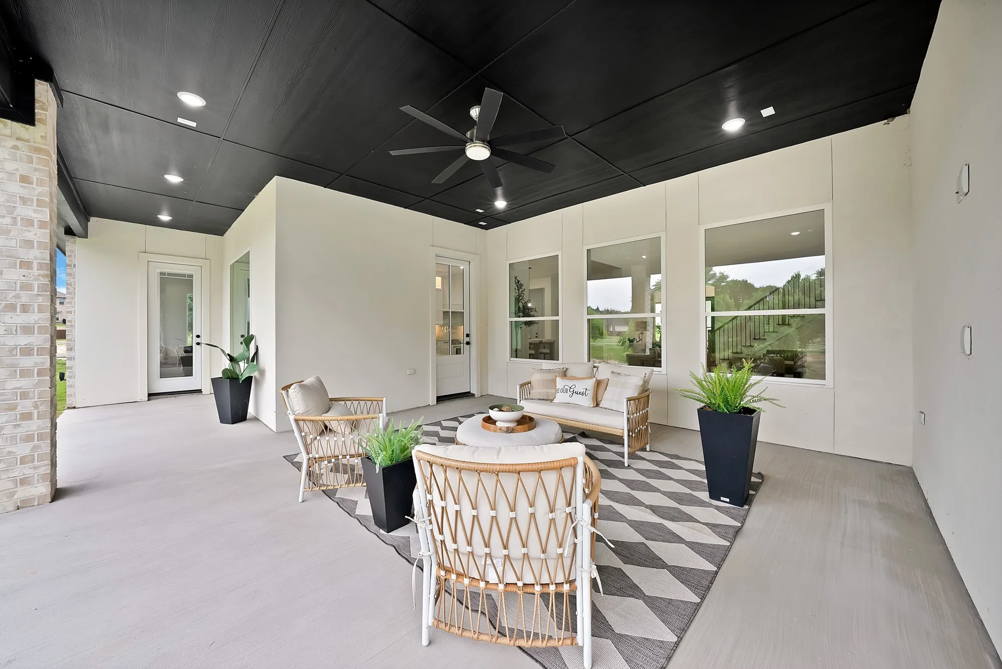 Covered patio featuring a black ceiling, recessed lighting, and a ceiling fan