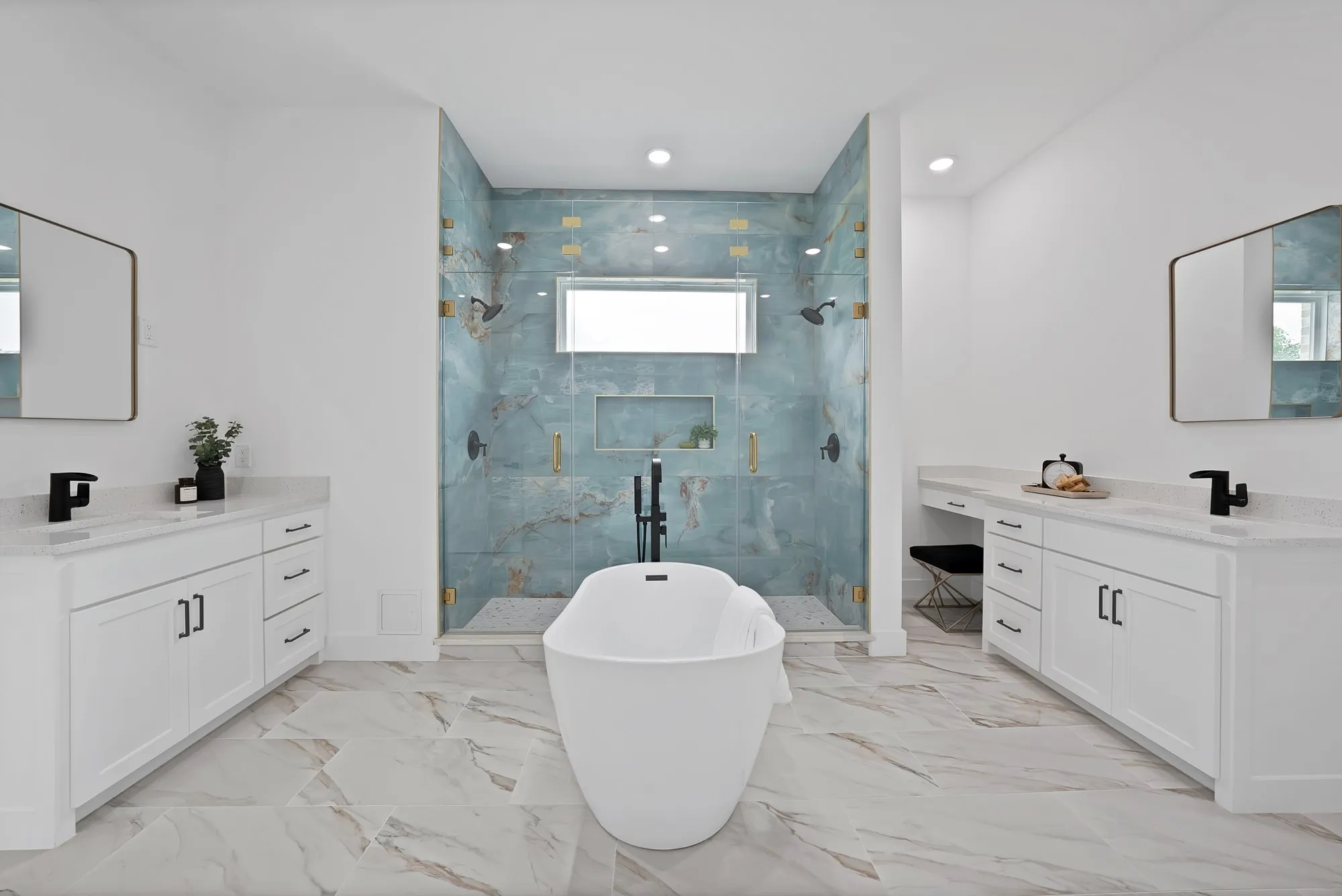 Dual vanity with quartz countertops, a freestanding soaking tub, a walk-in shower with full-height tile, and large format tile flooring