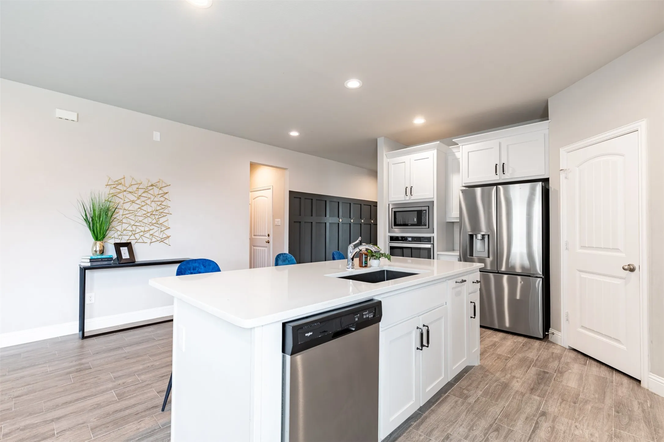 Convenient kitchen-side hallway providing easy access to the half bath, laundry room and attached garage.