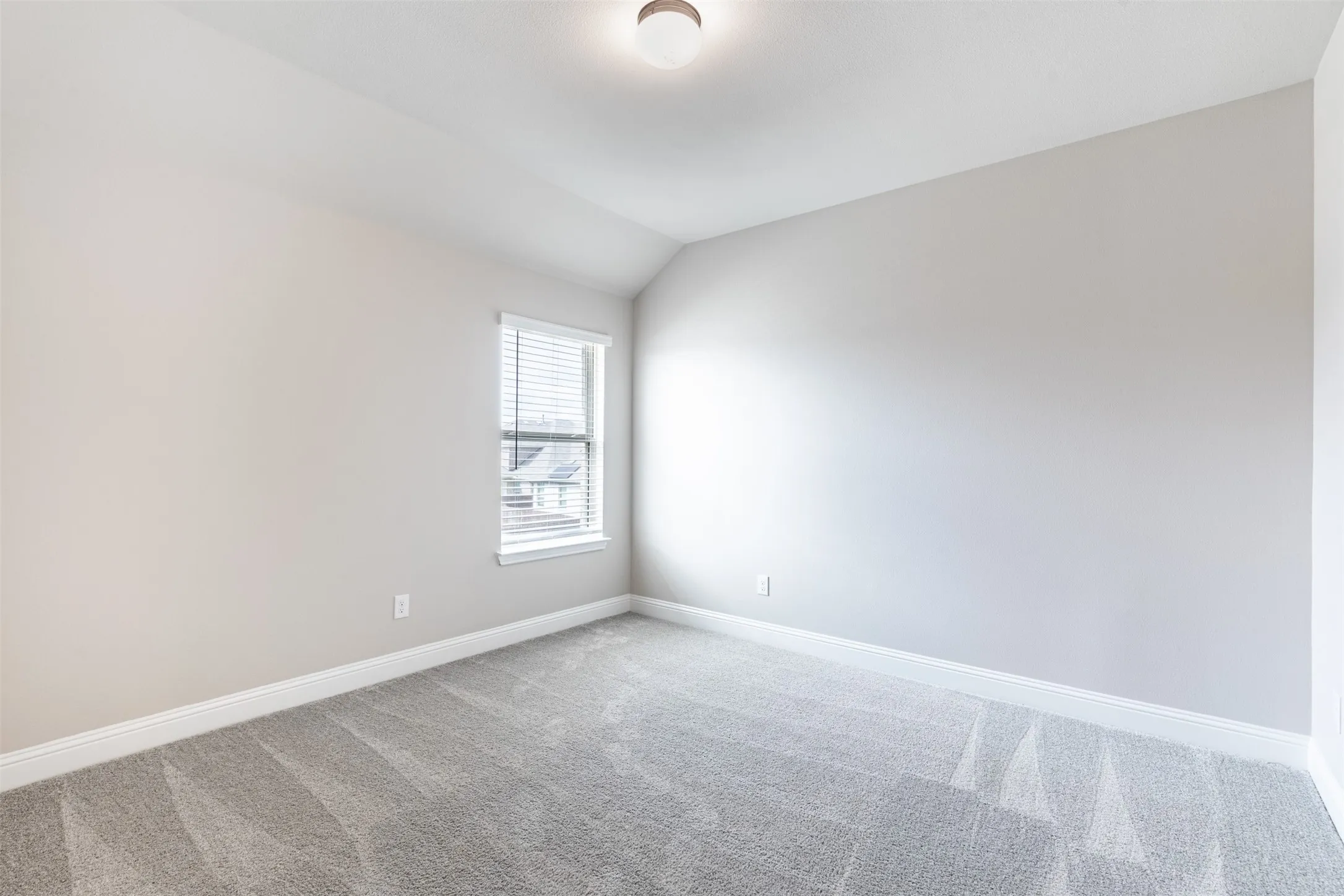 Spacious upstairs bedroom, three of three bedrooms on the second floor, featuring generous living space, natural light, and an oversized walk-in closet.