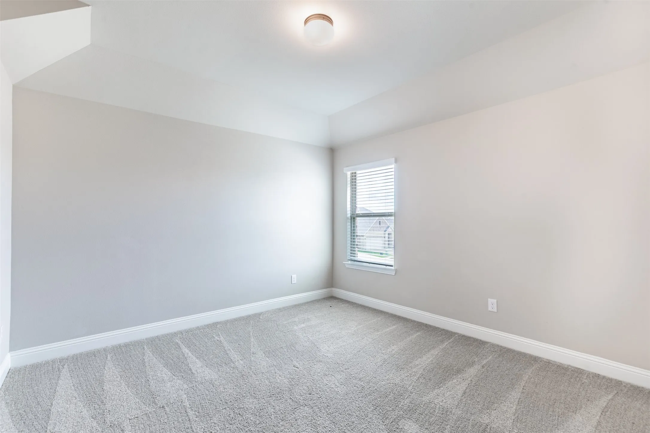 Spacious upstairs bedroom, two of three bedrooms on the second floor, featuring generous living space, natural light, and an oversized walk-in closet.