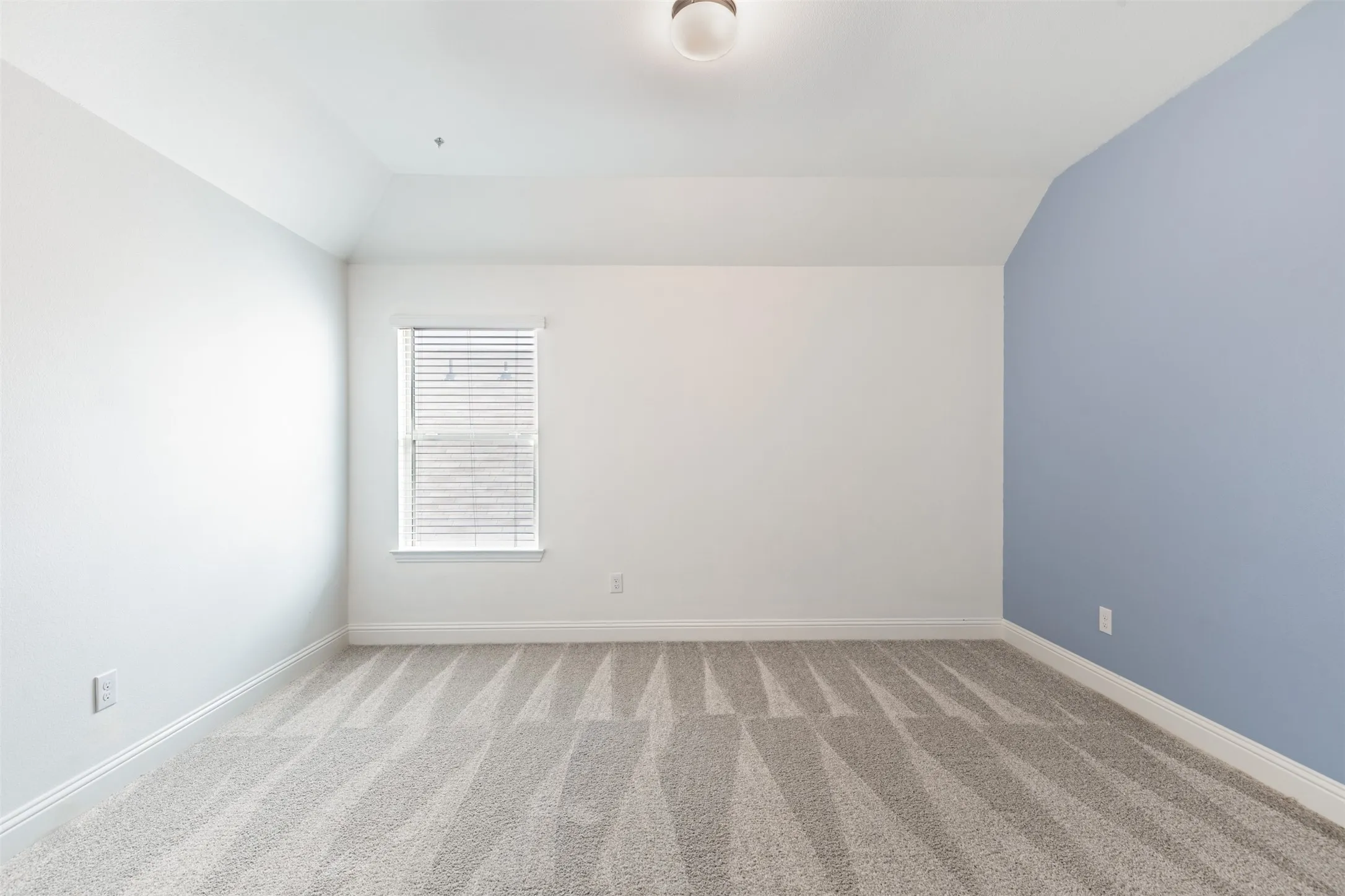 Spacious upstairs bedroom, one of three bedrooms on the second floor, featuring generous living space, natural light, and an oversized walk-in closet.