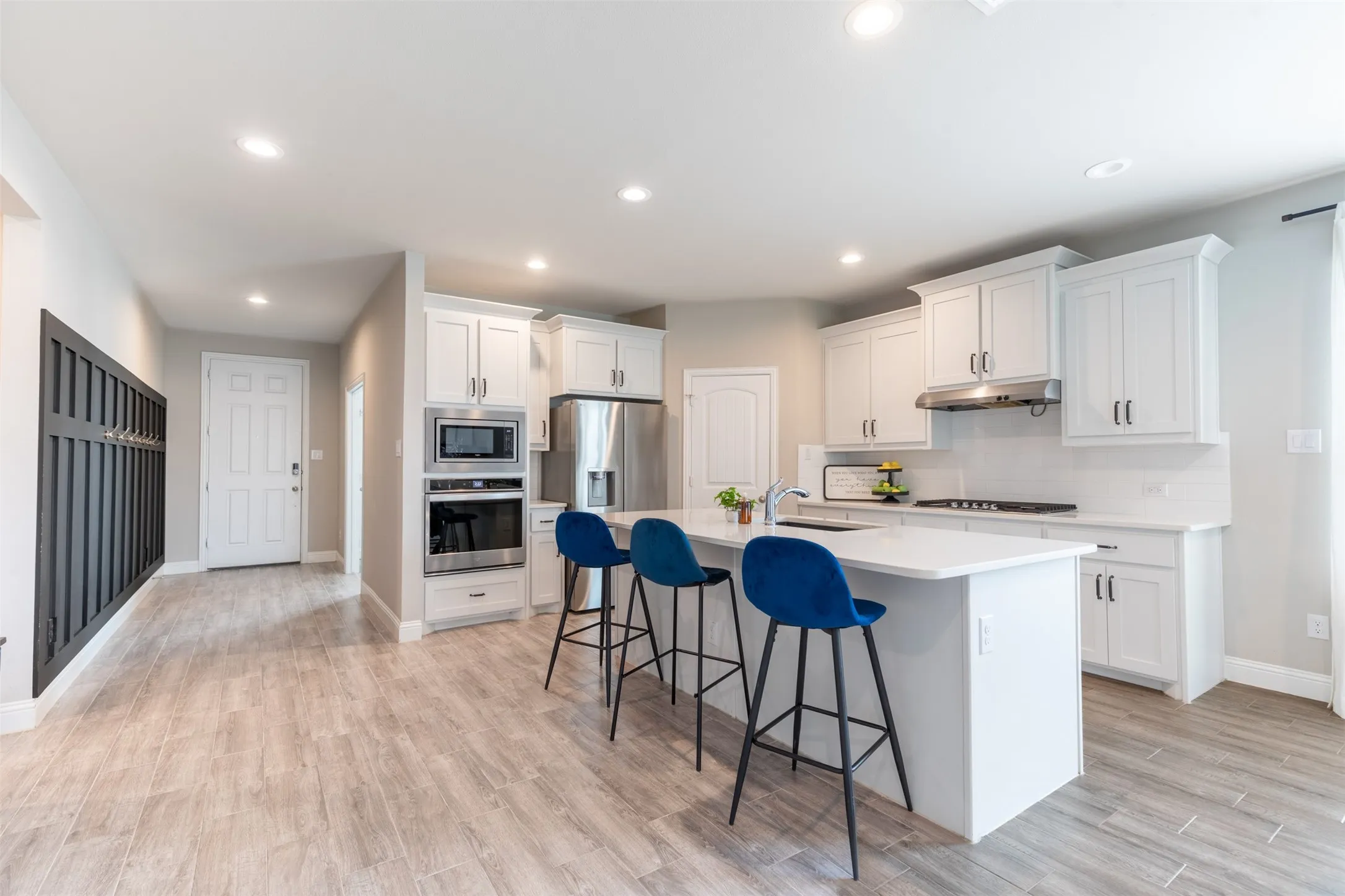 Spacious kitchen with a large, open layout flowing seamlessly from the entryway, creating an inviting sense of space and easy everyday living.