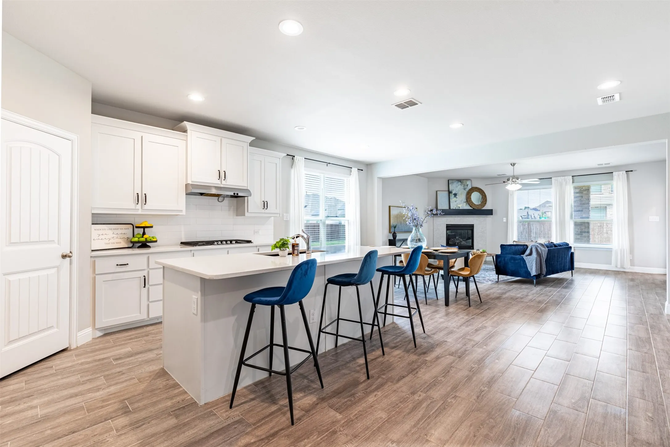 Spacious open-concept kitchen, eat-in dining area and living space filled with beautiful natural light and designed for seamless everyday living and entertaining.