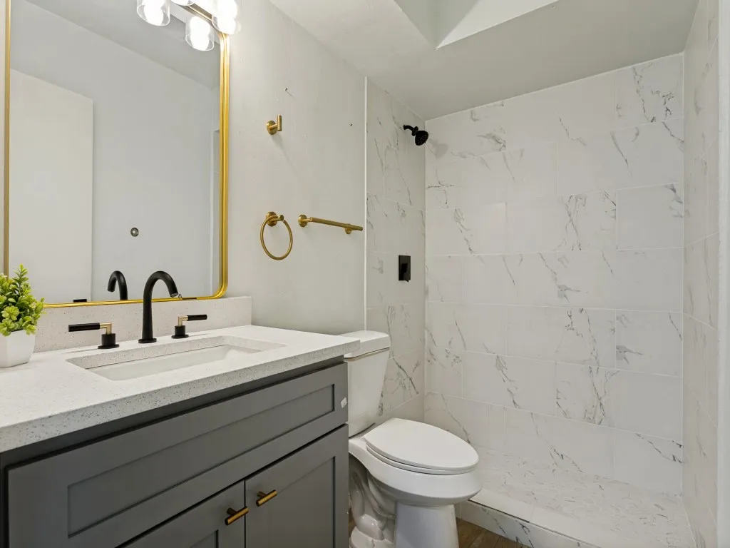 Vanity with a light-colored countertop, integrated sink, and dark cabinetry