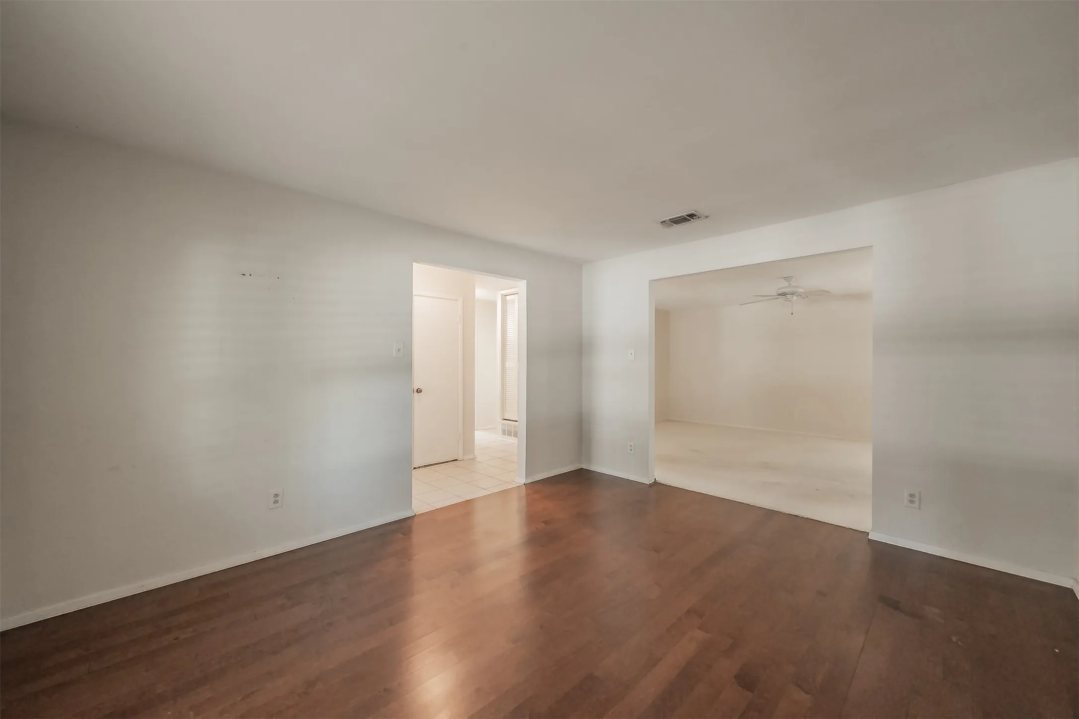 Hardwood-finish flooring, neutral wall tones, and overhead lighting