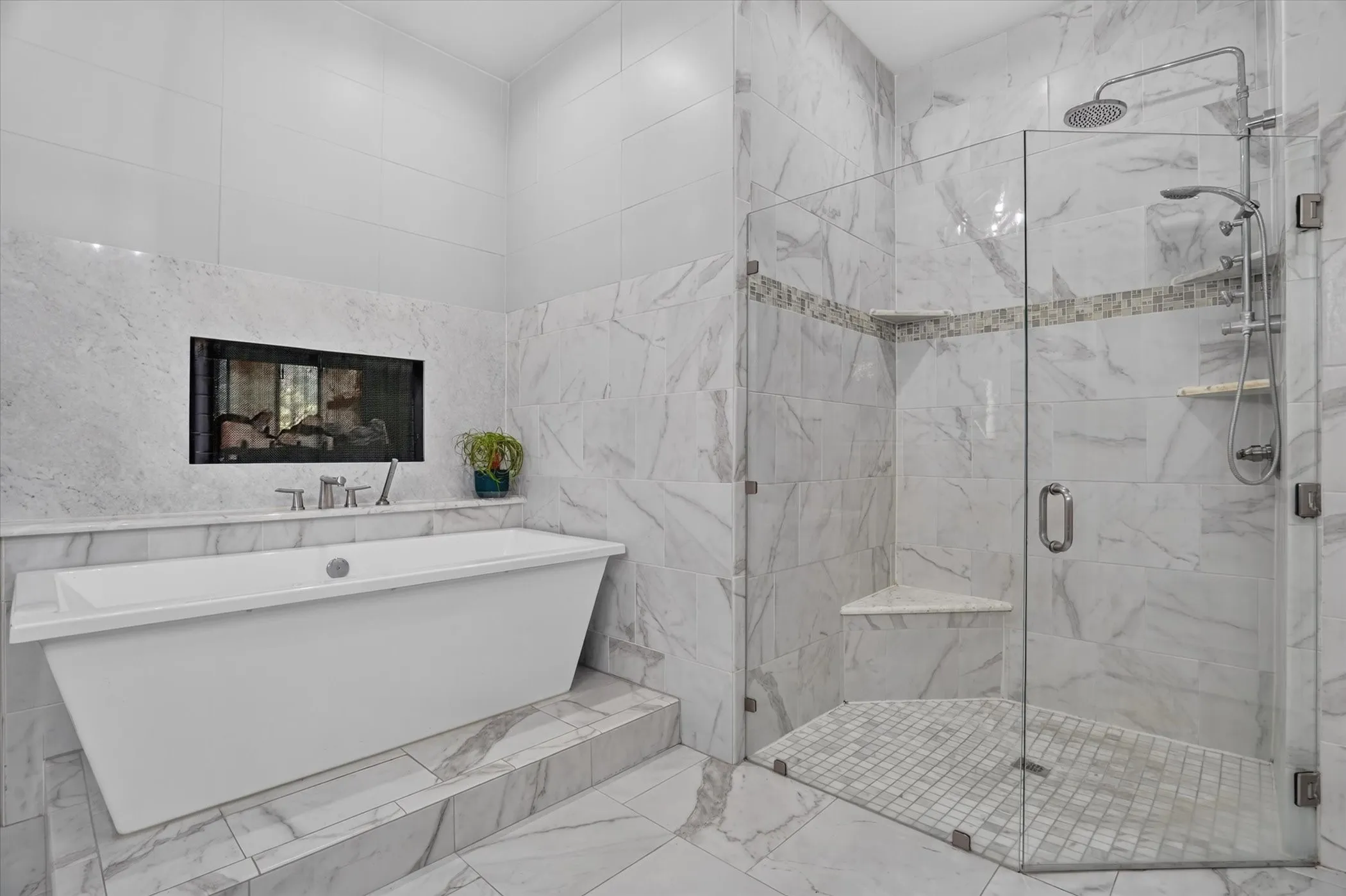 Freestanding soaking tub with a built-in fireplace, glass-enclosed shower, rain shower head, body sprays and marble-finish tile flooring