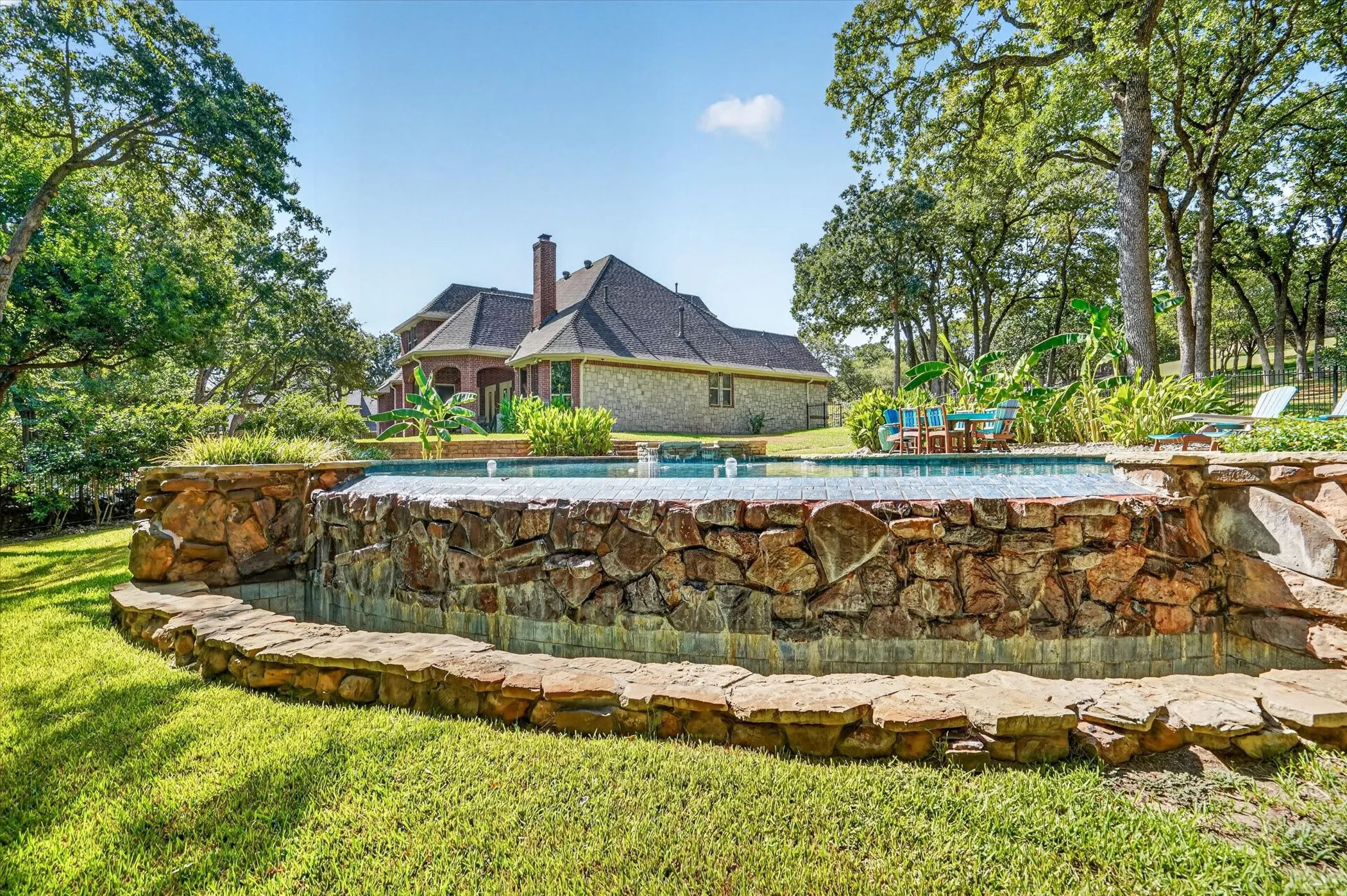 Water feature with natural stone surround an integrated pool
