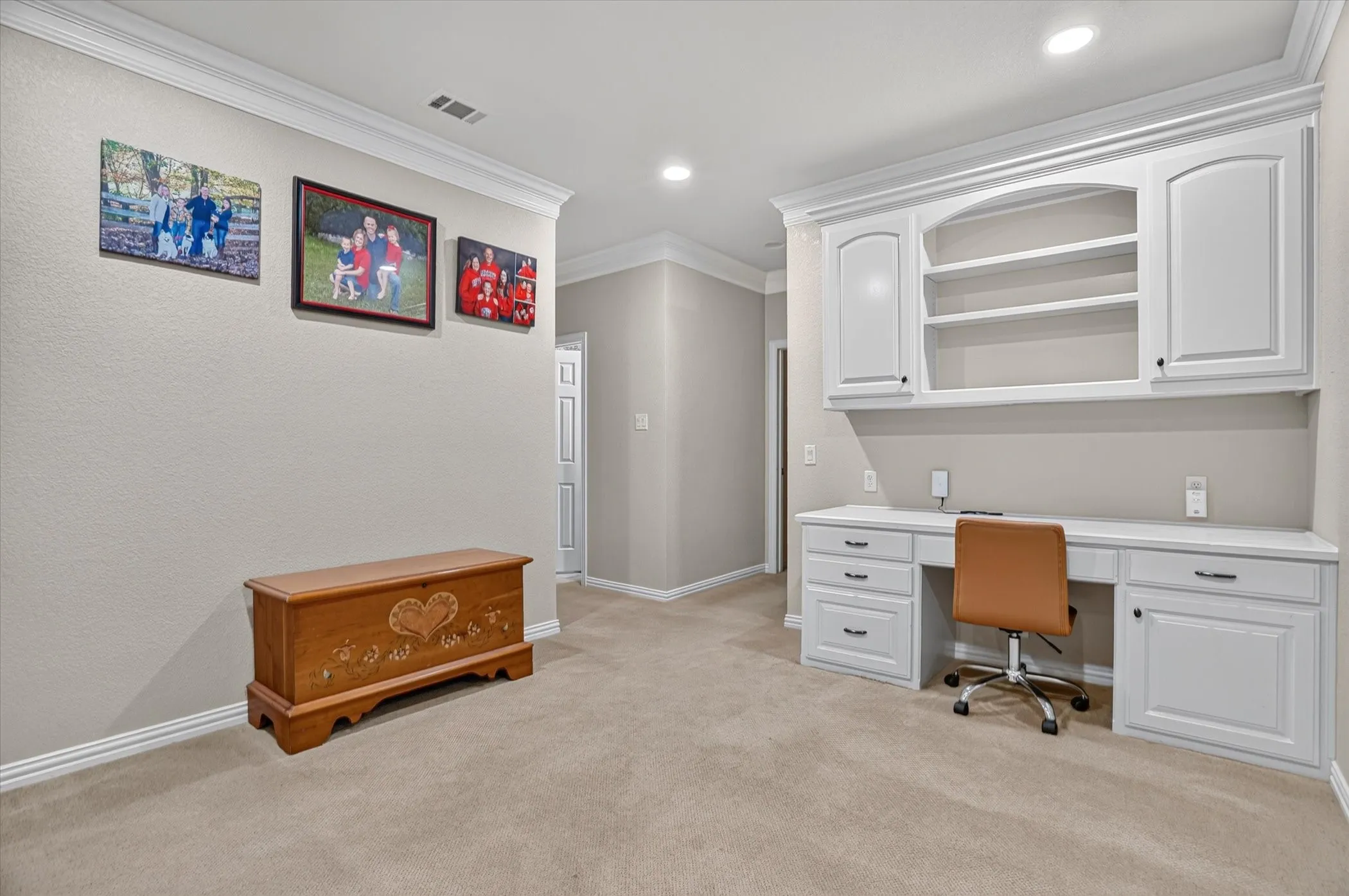 Built-in desk with cabinetry and shelving