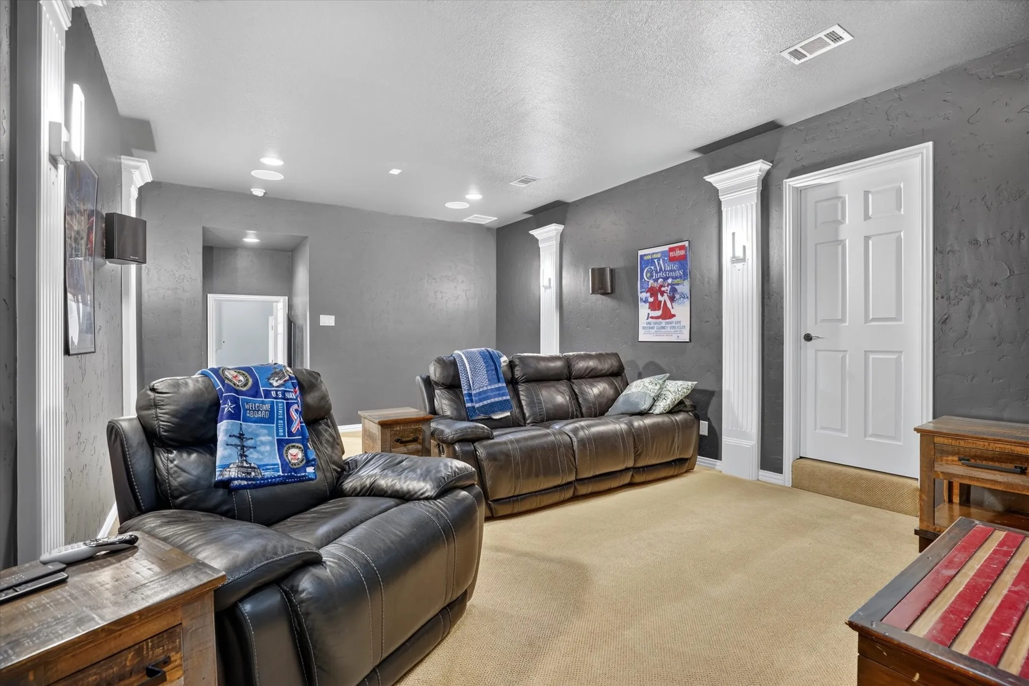 Recessed lighting, gray walls, white trim, white paneled door, and neutral carpeting
