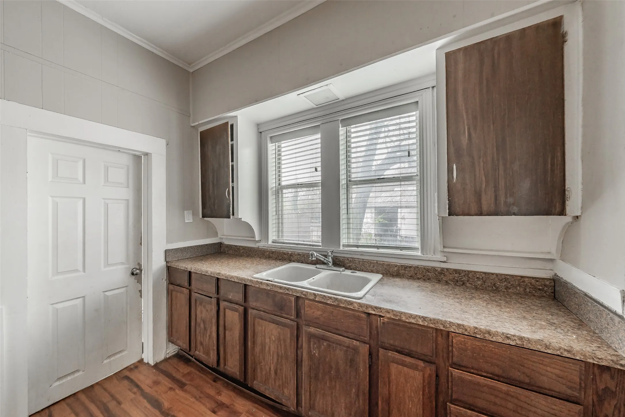 Wood-finish flooring with base cabinetry and a laminate countertop