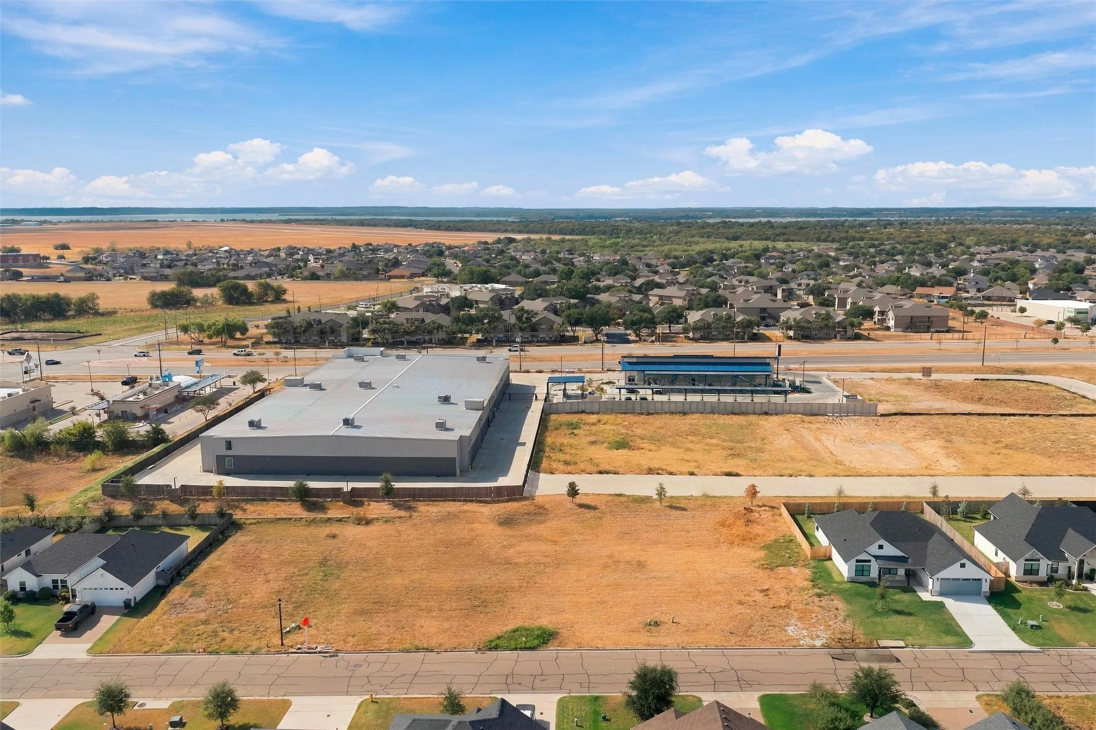 Expansive undeveloped lot with surrounding residential and commercial properties