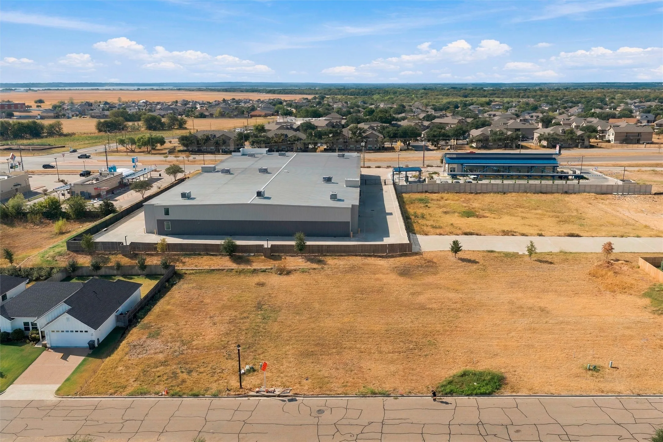 Expansive undeveloped lot with existing street access and a clear perimeter