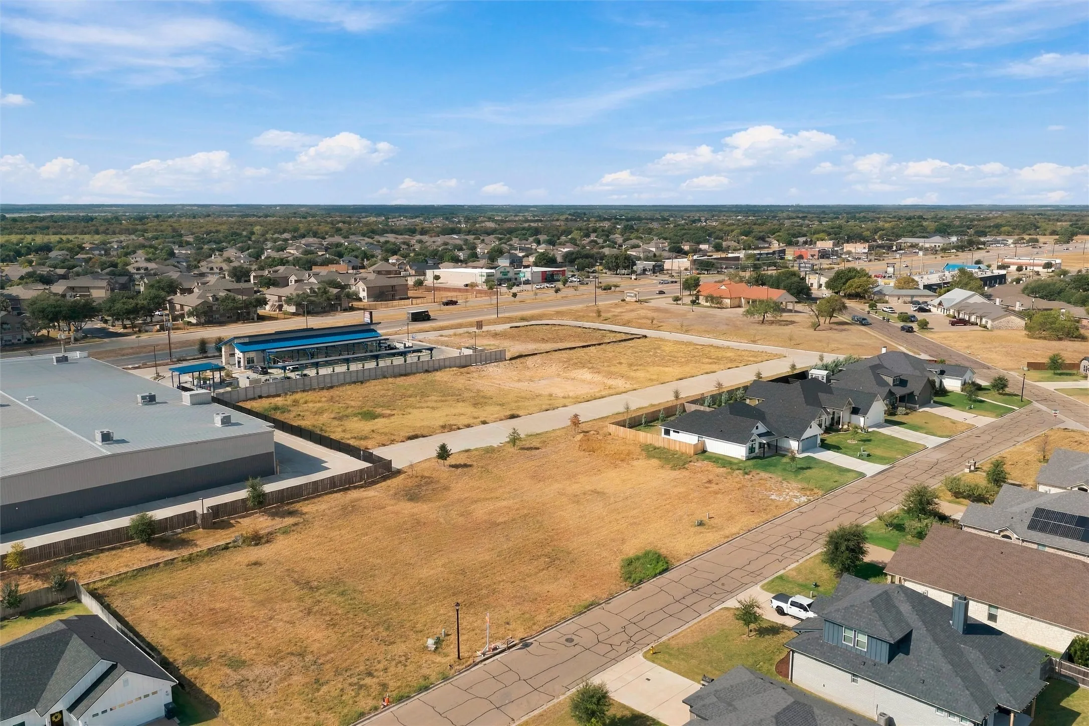 Expansive open lot featuring undeveloped land and established roadways