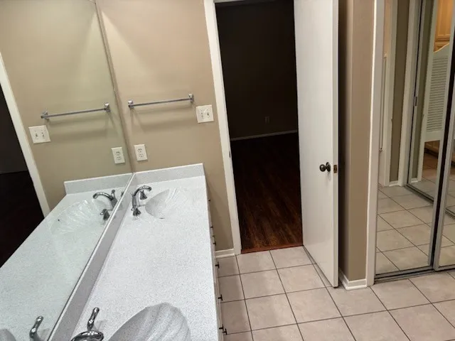 Dual vanity with integrated sinks and chrome fixtures