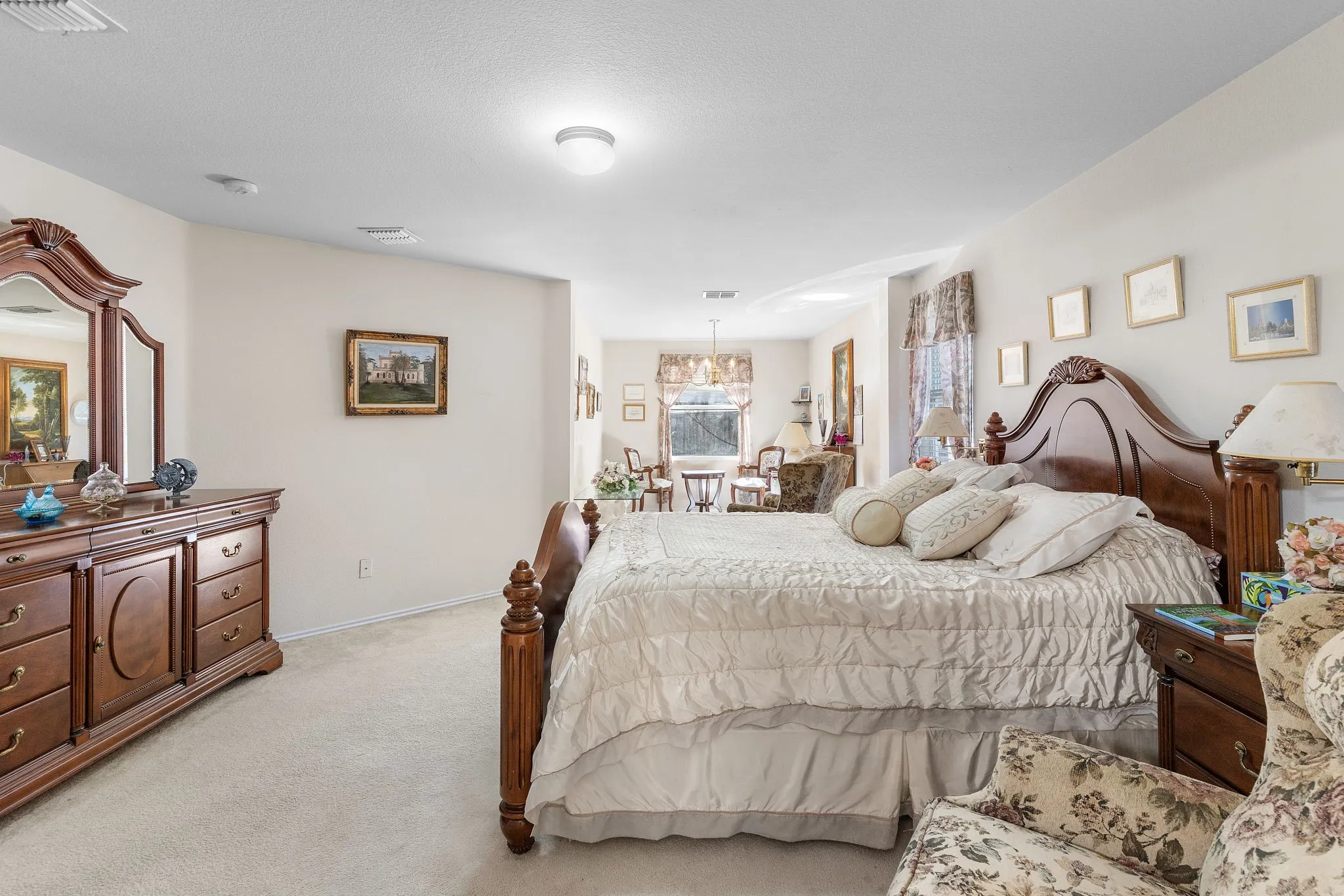 Recessed lighting, light-toned carpeting, and neutral wall tones