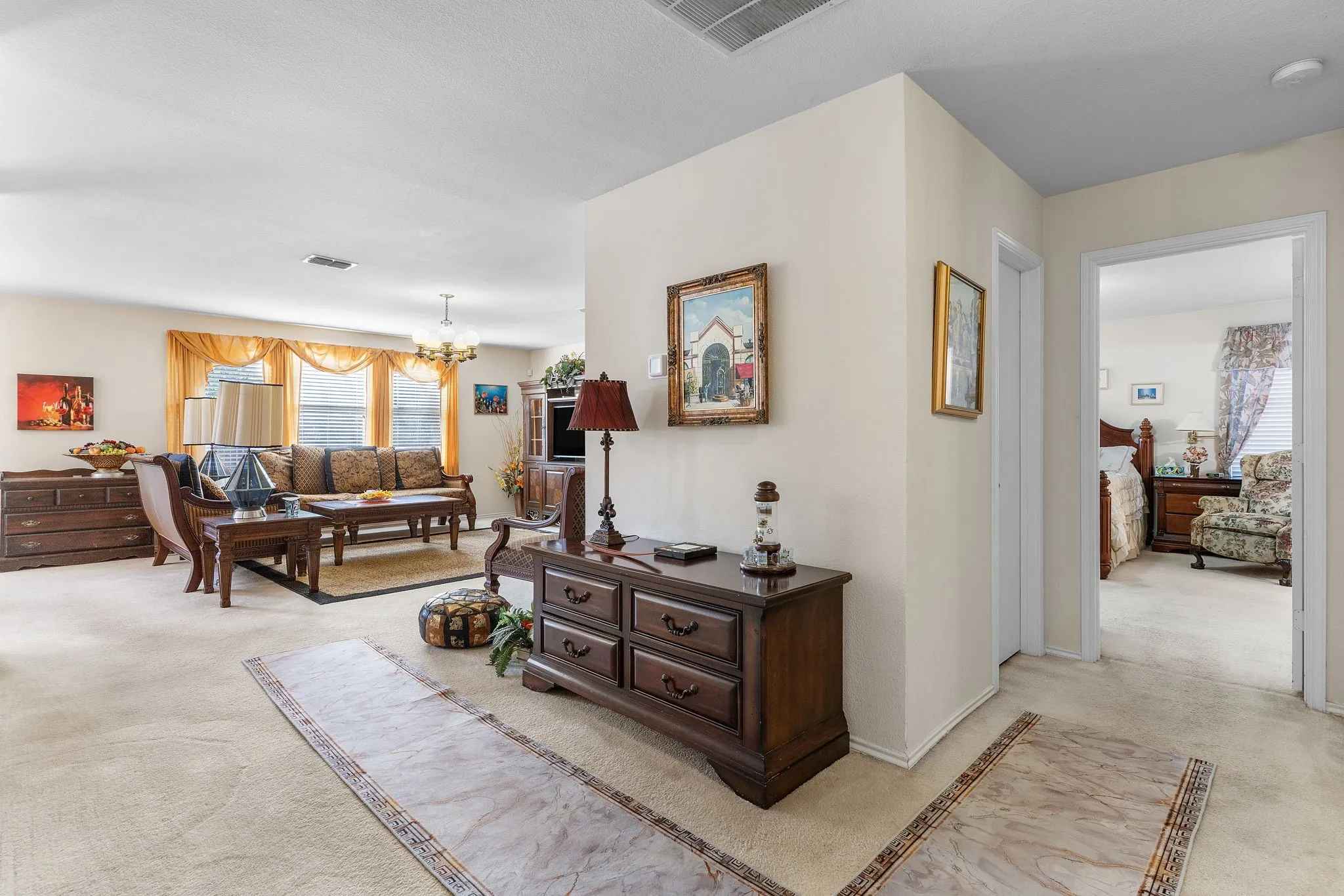 Carpeted flooring throughout, recessed lighting, and a chandelier lighting fixture