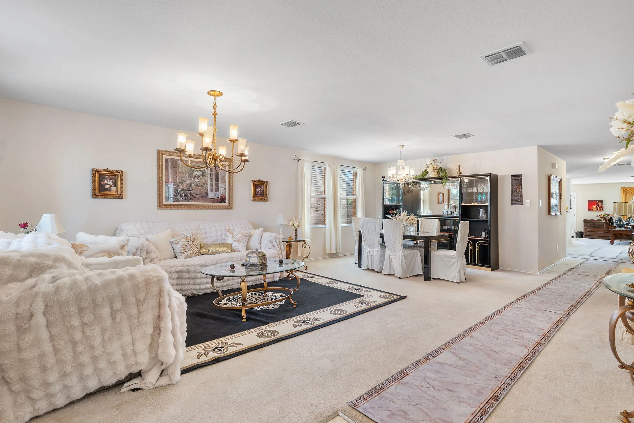 Recessed lighting fixtures complement a brass chandelier