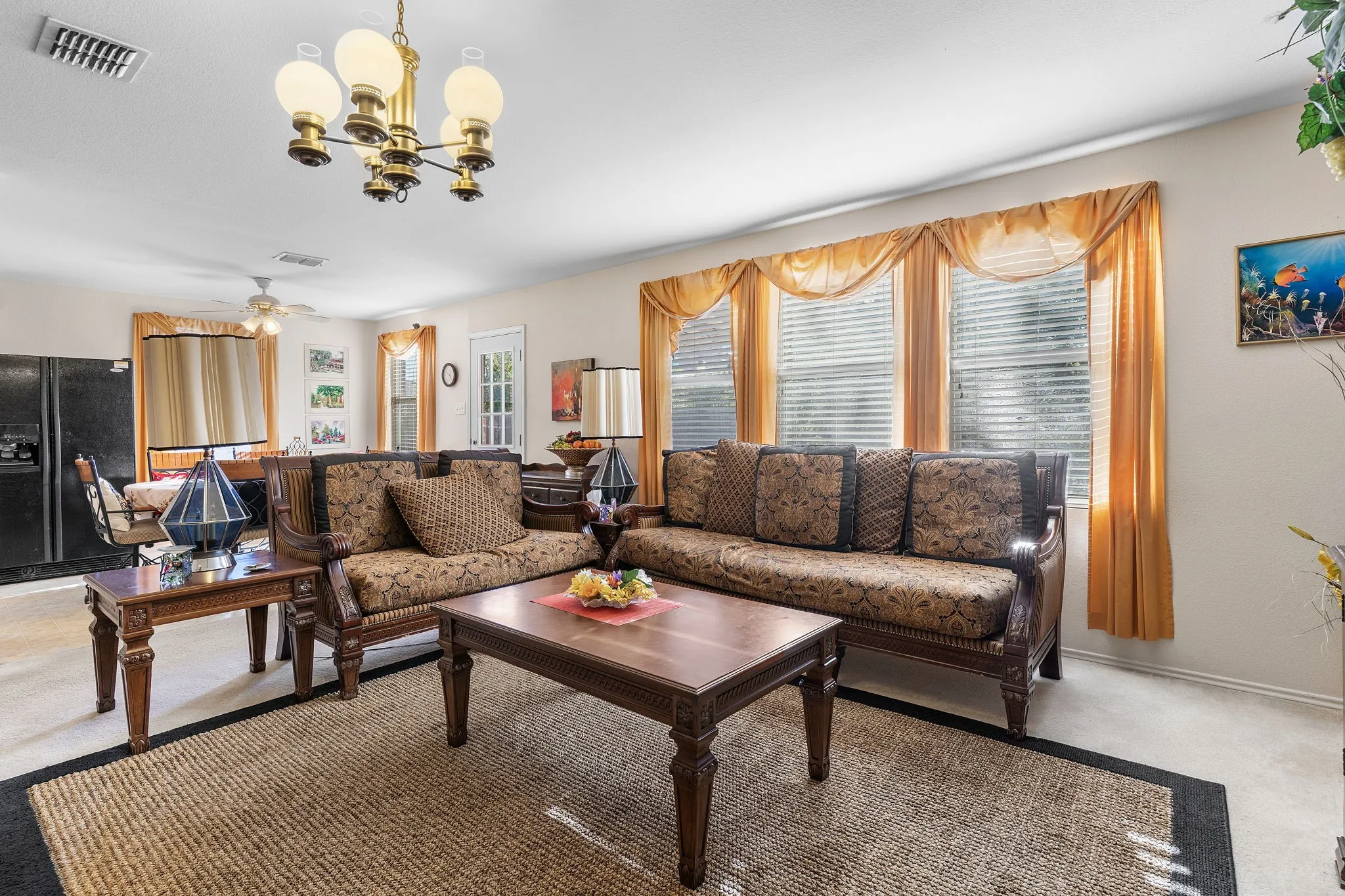 Recessed lighting, chandelier, and a ceiling fan provide ample illumination