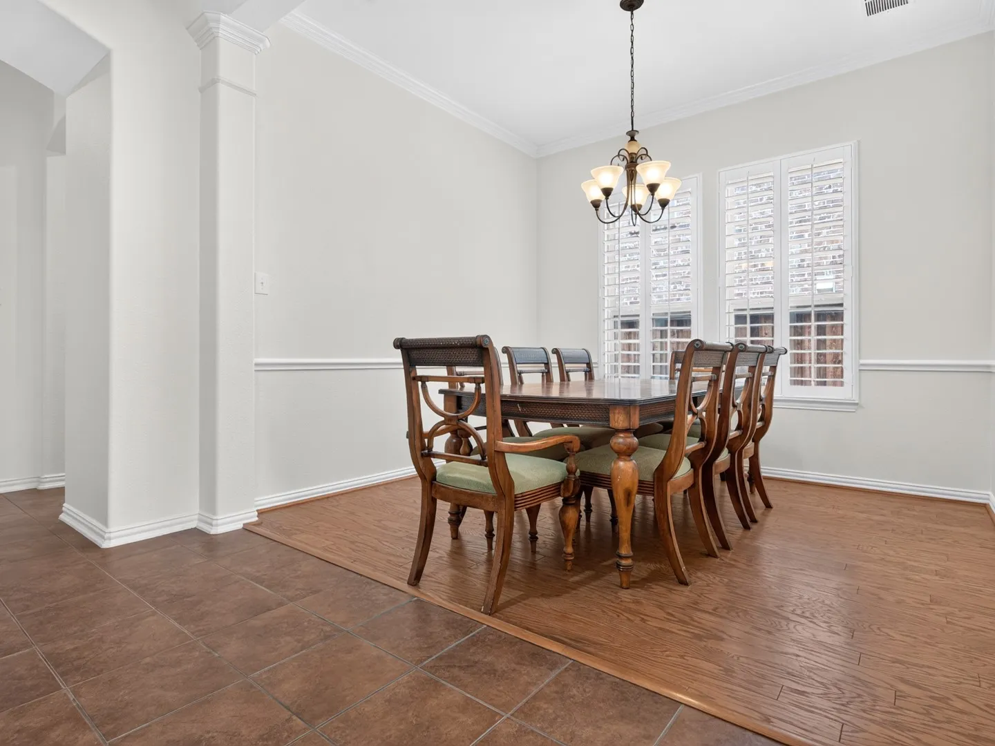 Recessed lighting, crown molding, chair rail, wood-finish flooring, and white plantation shutters