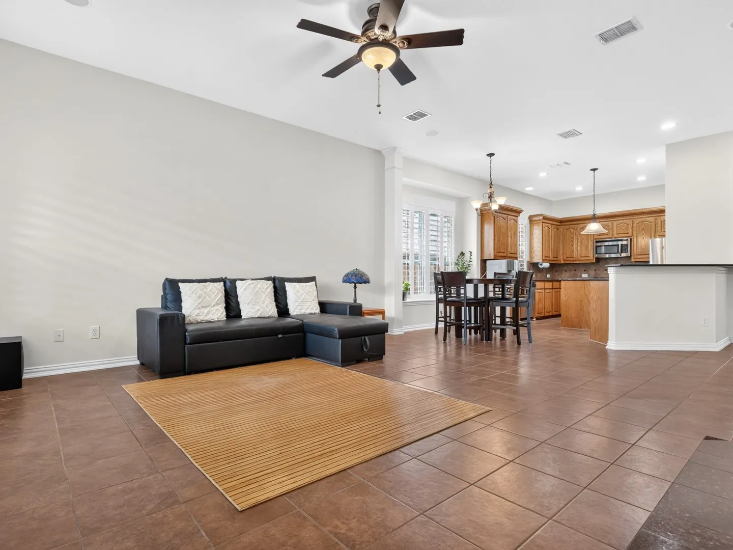 Spacious interior with tile flooring, recessed lighting, and a ceiling fan