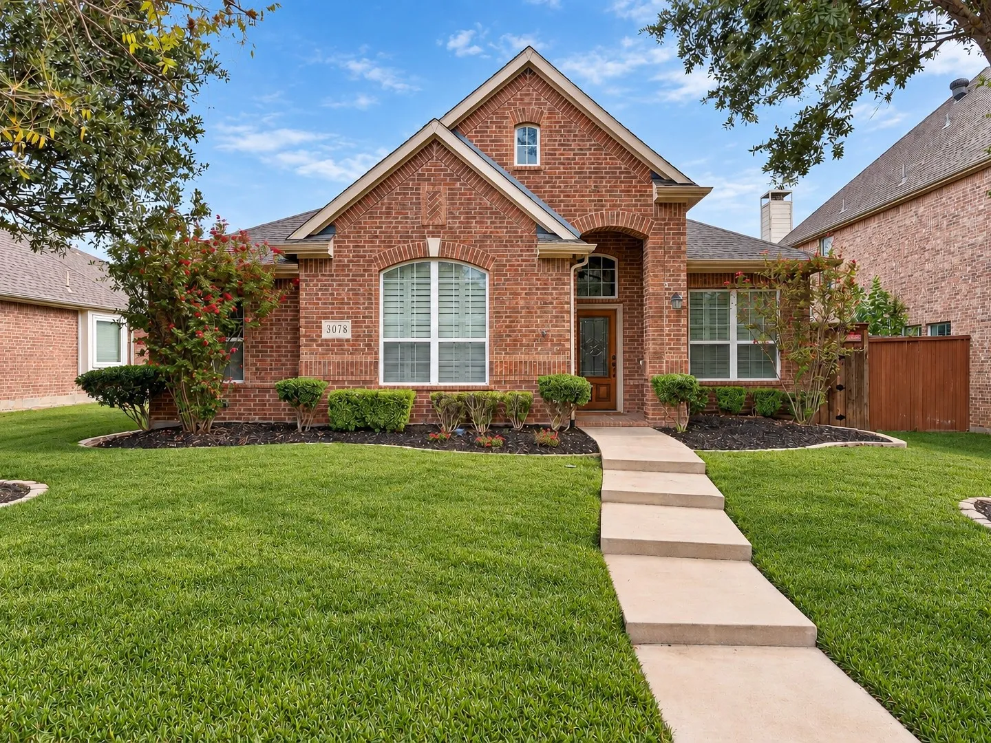 Brick exterior with an arched entry and transom window