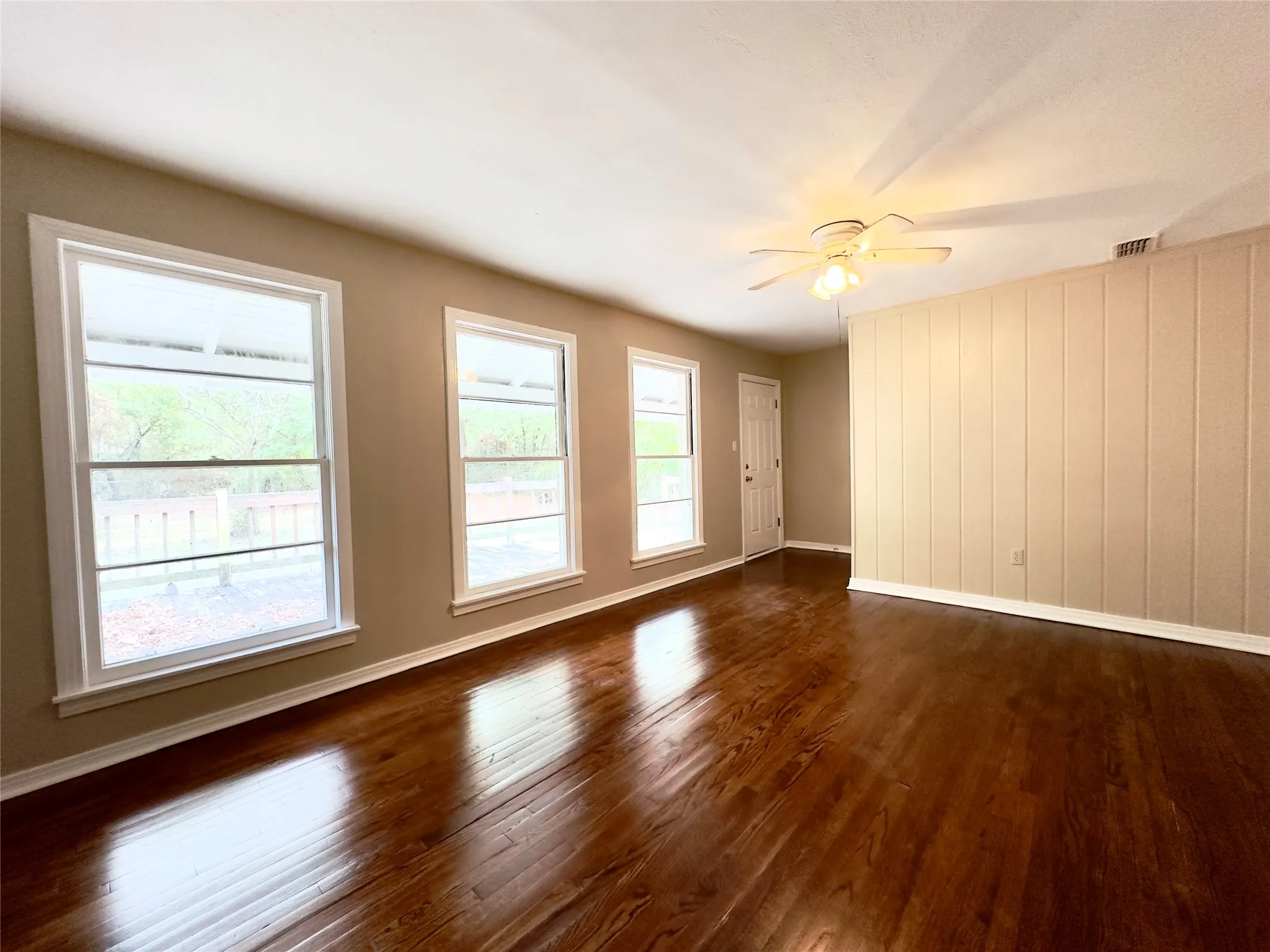 Rich wood-finish flooring complemented by neutral wall tones