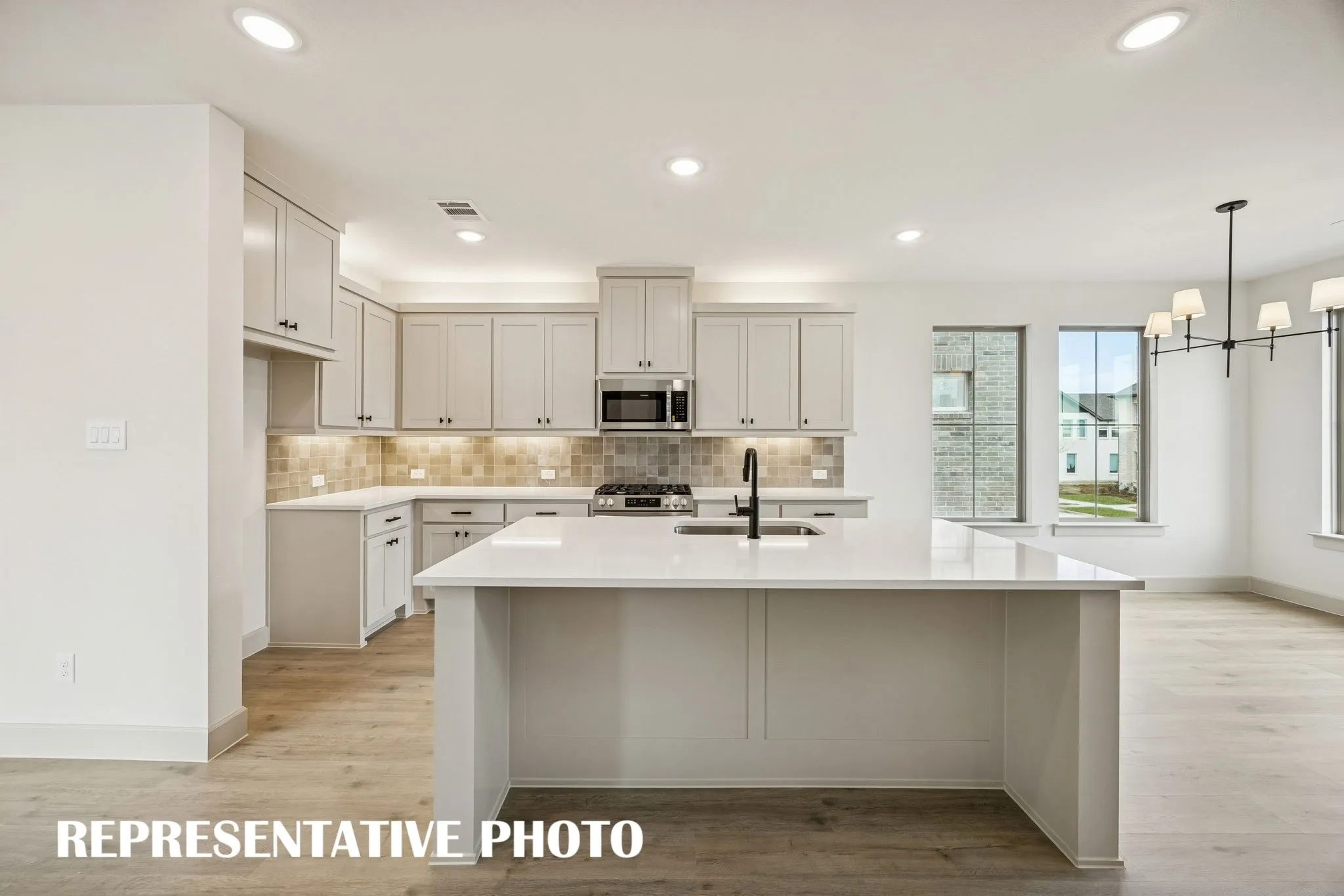 This dream home features a spacious kitchen island where friends and family are sure to gather round!  REPRESENTATIVE PHOTO