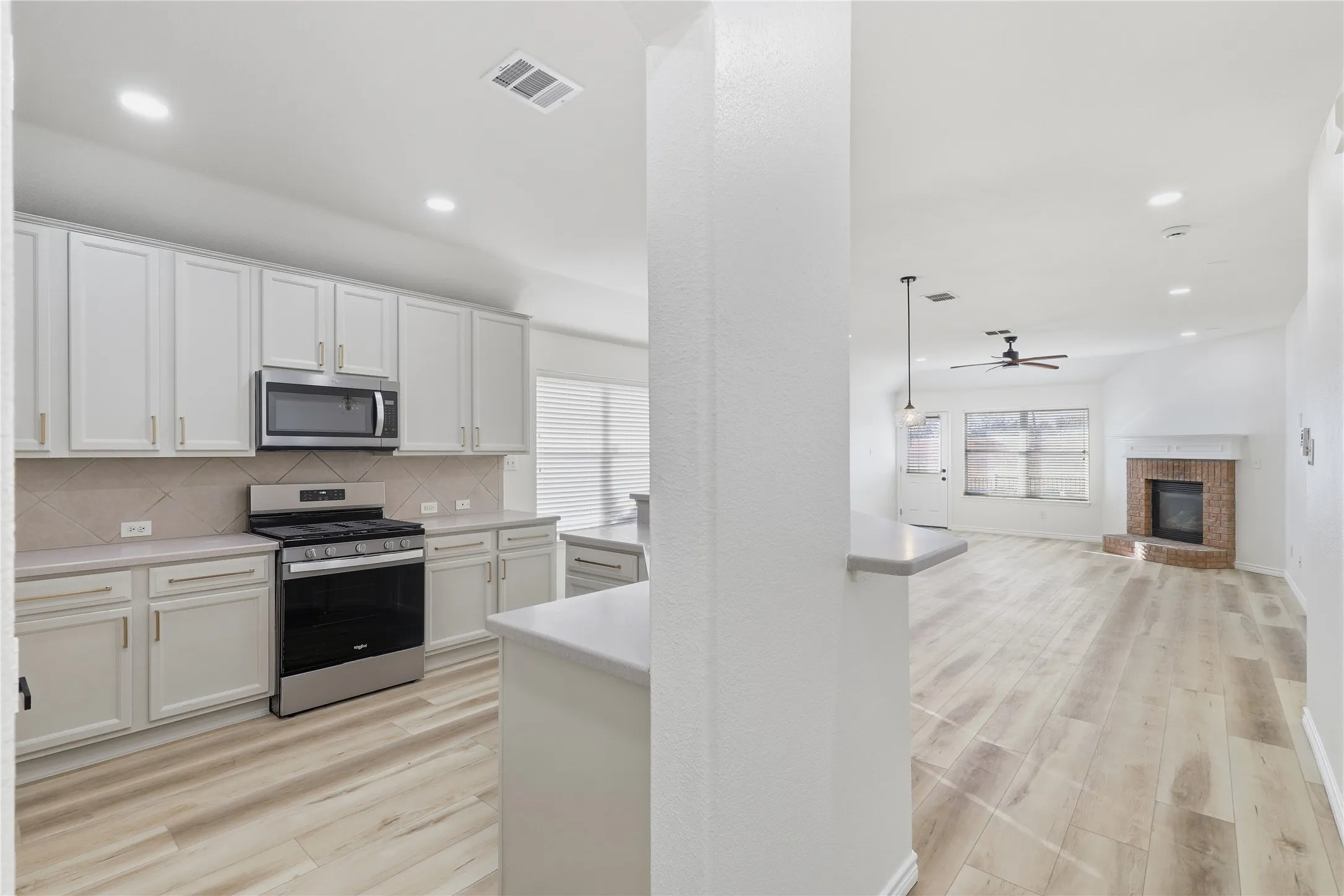 Kitchen featuring white cabinetry, stainless steel appliances, and a tiled backsplash
