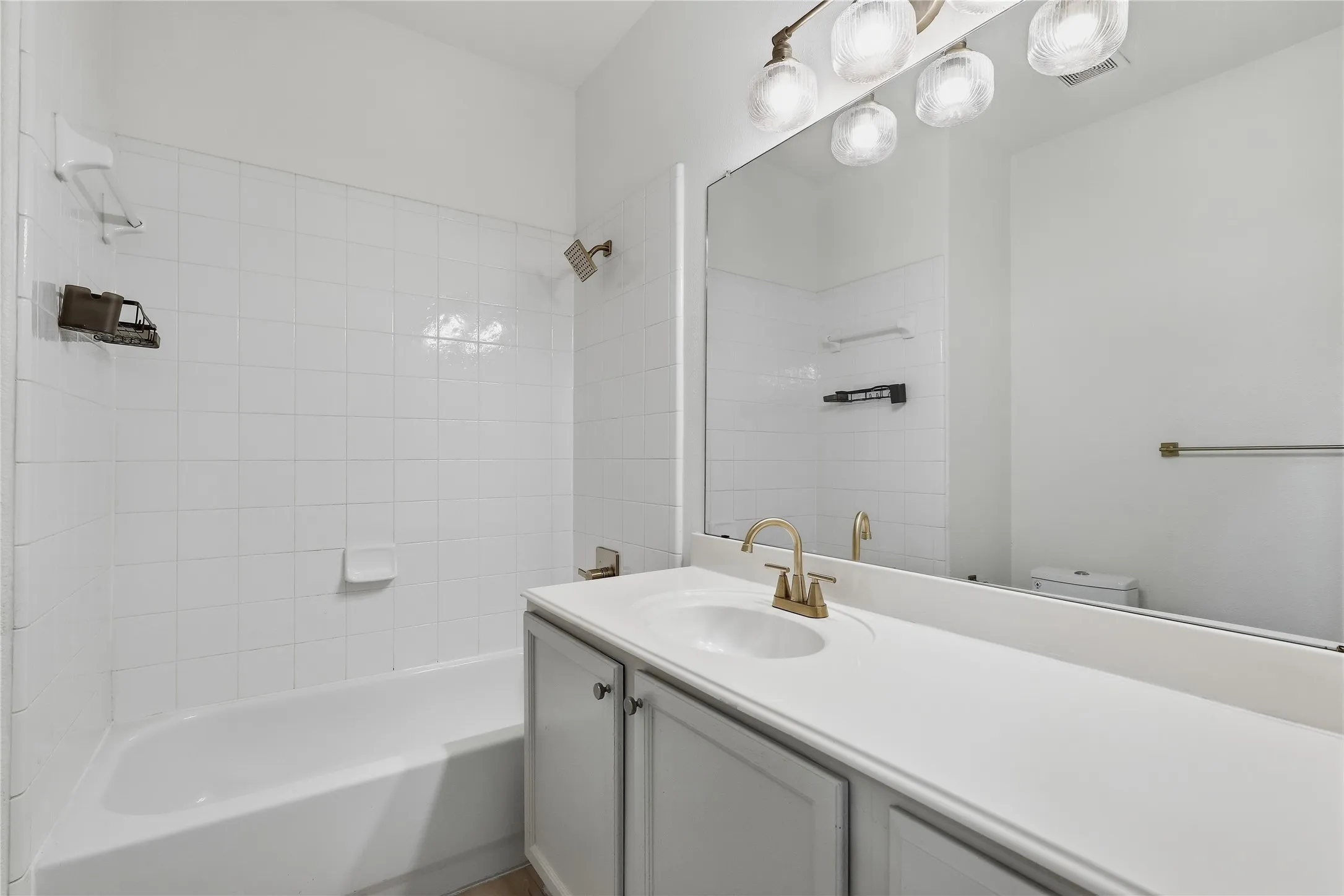 White wire shelving, white interior door, light wood-finish flooring, and white wall paint