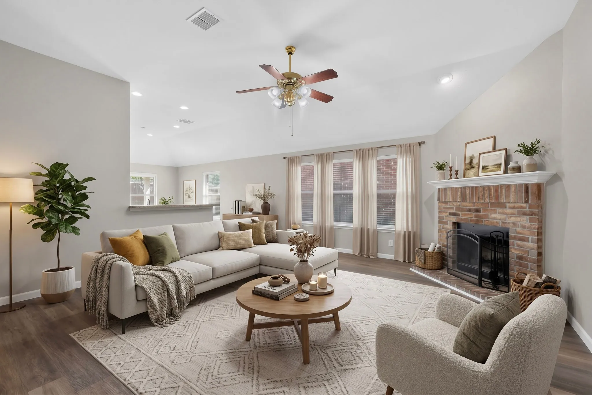 Vaulted ceilings with a ceiling fan, brick fireplace with a white mantel, recessed lighting, wood-finish flooring, and multiple windows